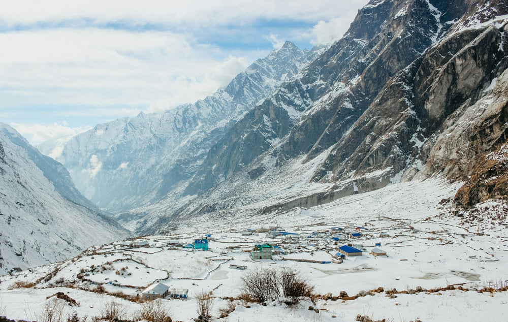 A village on the snowy floor of the Langtang valley, below steep Himalayan peaks