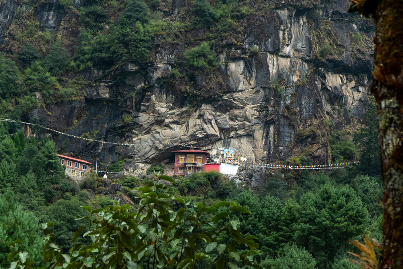 Traditional mountain village nestled in a valley with lush greenery