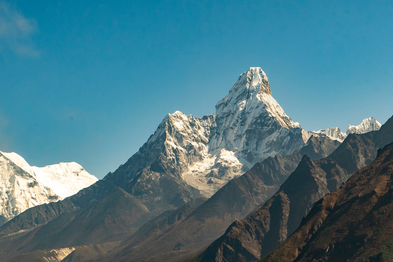 Snow-capped mountain peak with clear blue sky