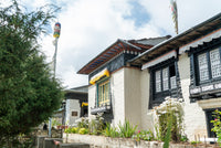 Traditional building with black and white architecture in a garden setting