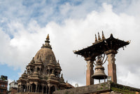 Traditional Nepalese temple with intricate architecture against a cloudy sky