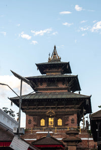 Traditional Nepalese temple with multiple tiers against a blue sky