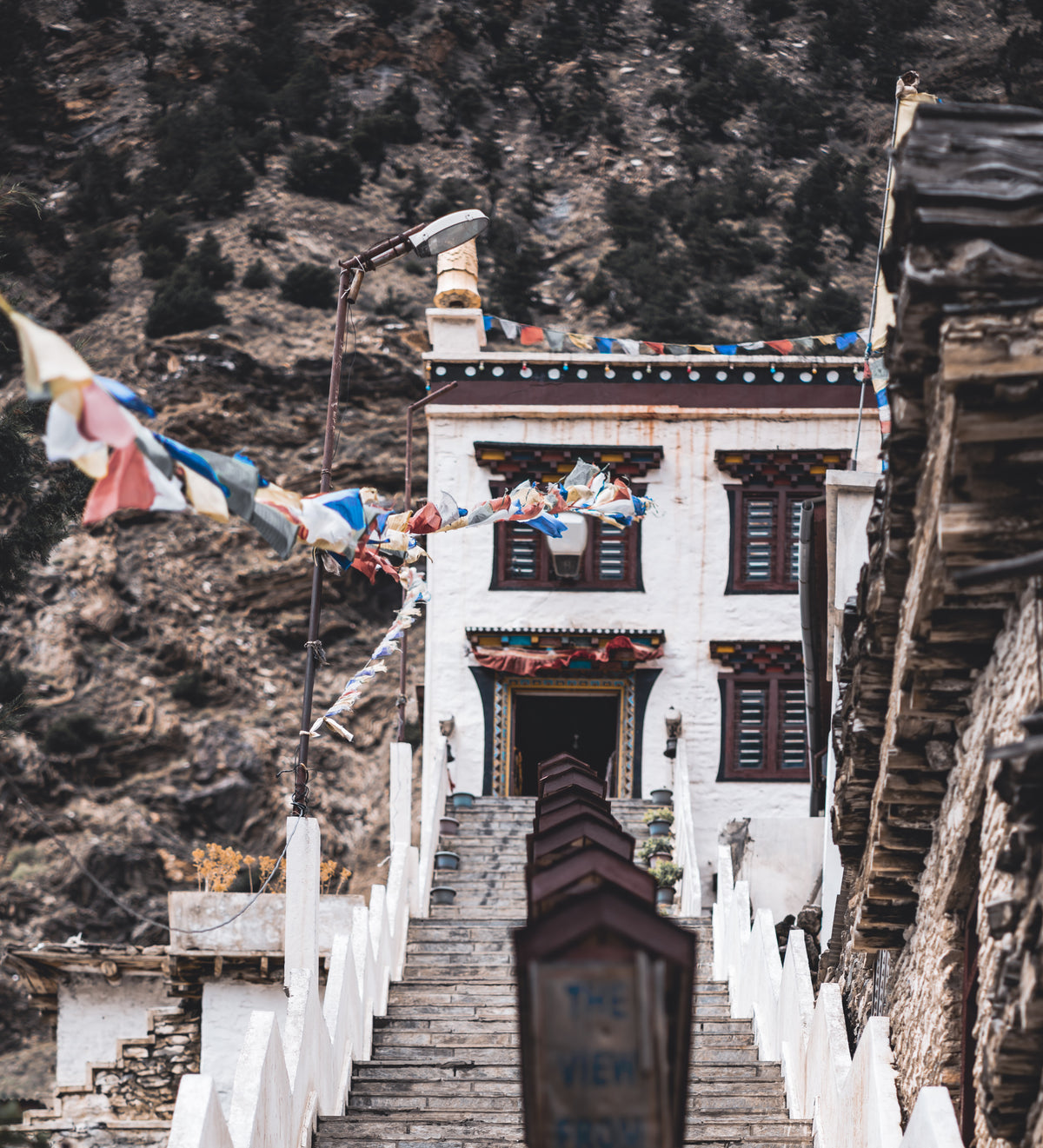 A stairway up to a monastery hung with prayer flags, in Upper Mustang