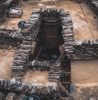 Archaeological site with stone structures and wooden door