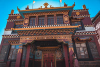 Traditional architectural style with intricate designs and a blue sky background