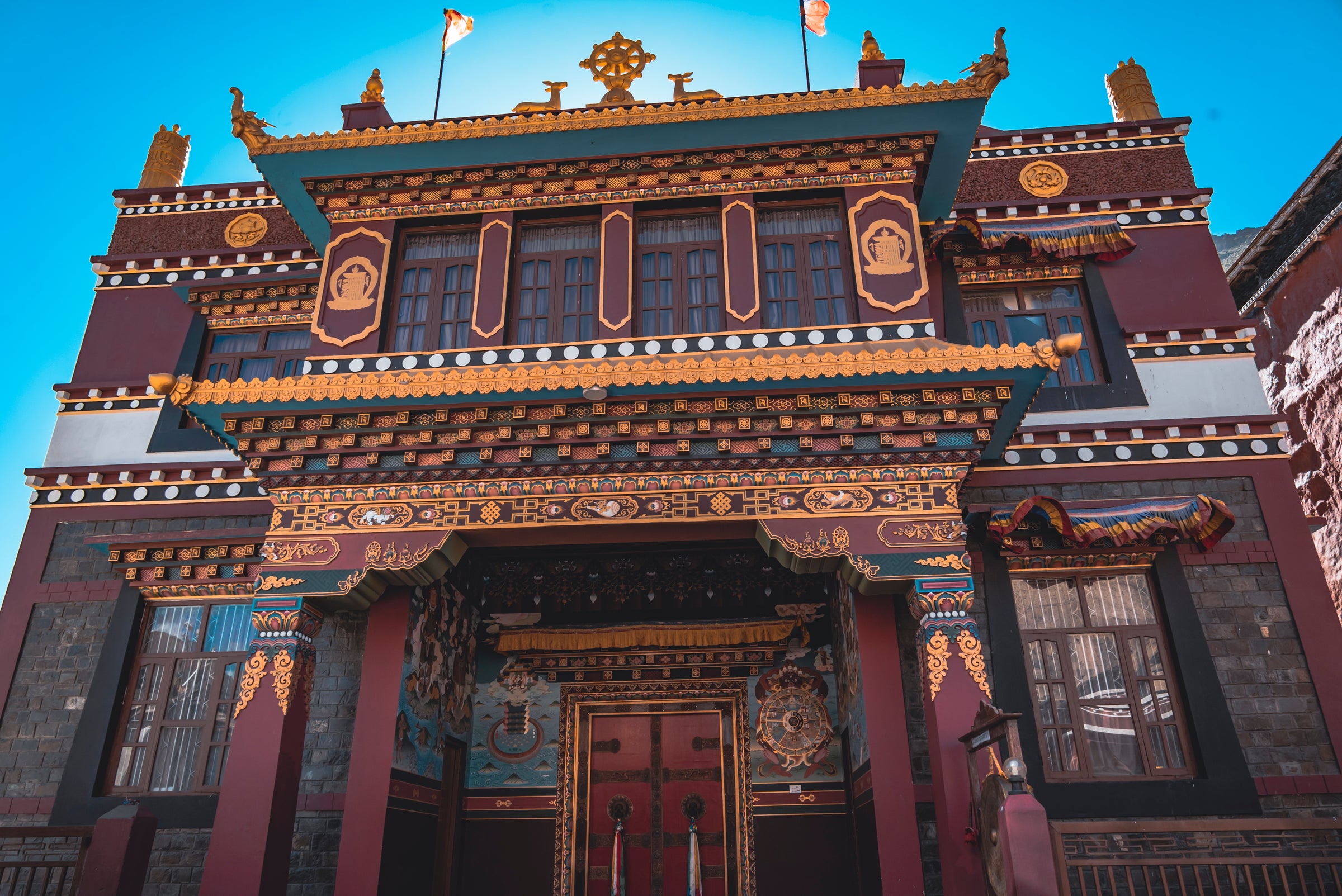 Traditional architectural style with intricate designs and a blue sky background