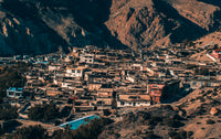 Small town or village nestled in a mountainous area with houses and buildings.