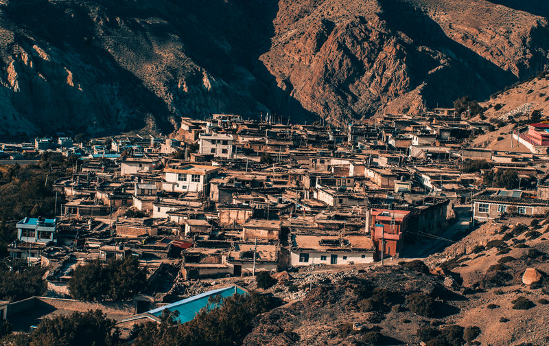 Small town or village nestled in a mountainous area with houses and buildings.