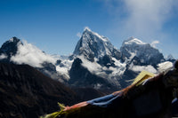 Snow-capped mountain peaks with a colorful banner in the foreground