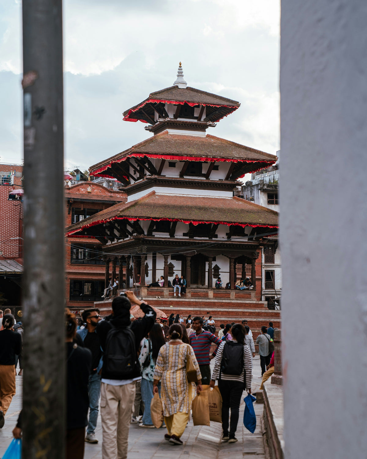 Traditional Nepalese temple with people around it