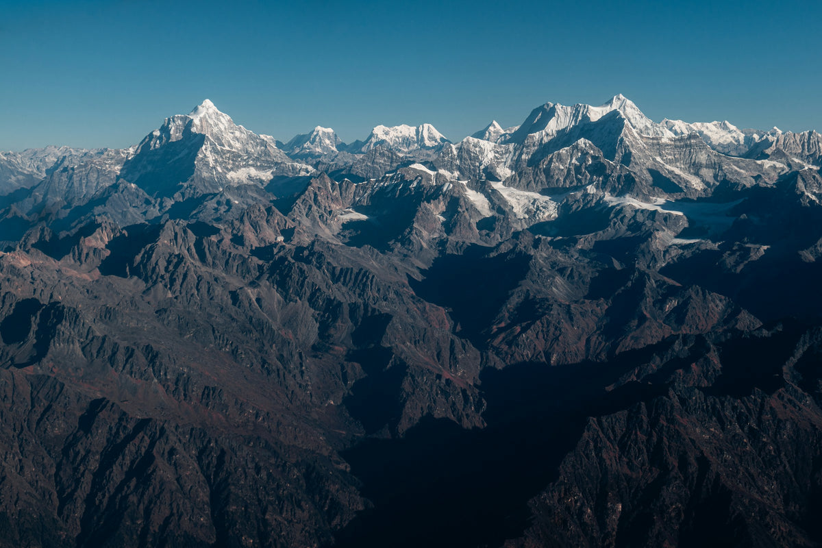 Snow-capped mountain range under a clear blue sky