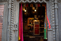 Decorative wooden door with colorful fabric in a traditional setting