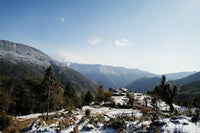 Scenic view of snow-covered mountains with a clear blue sky.