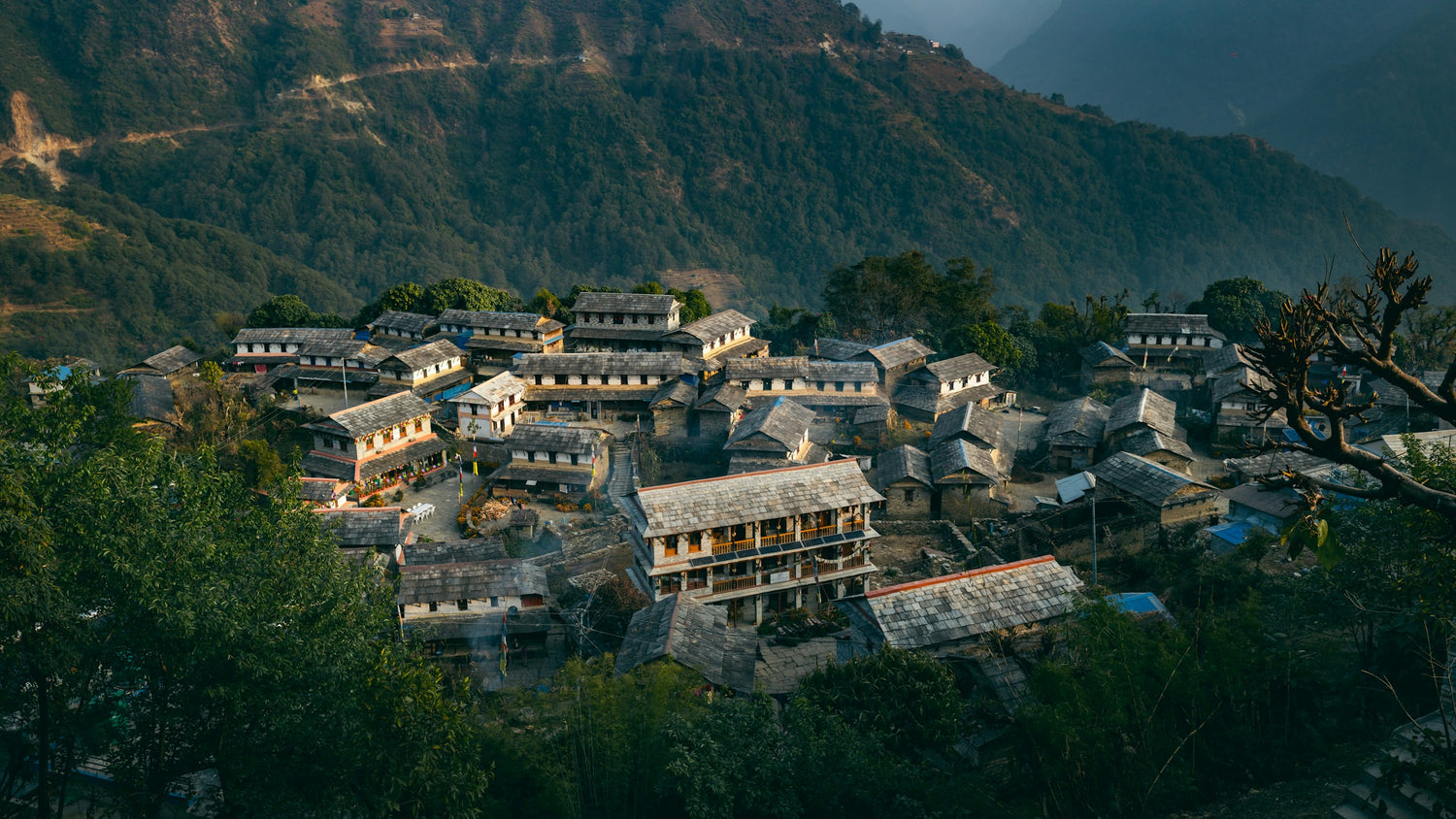 Small village nestled in a mountainous area with houses and buildings.