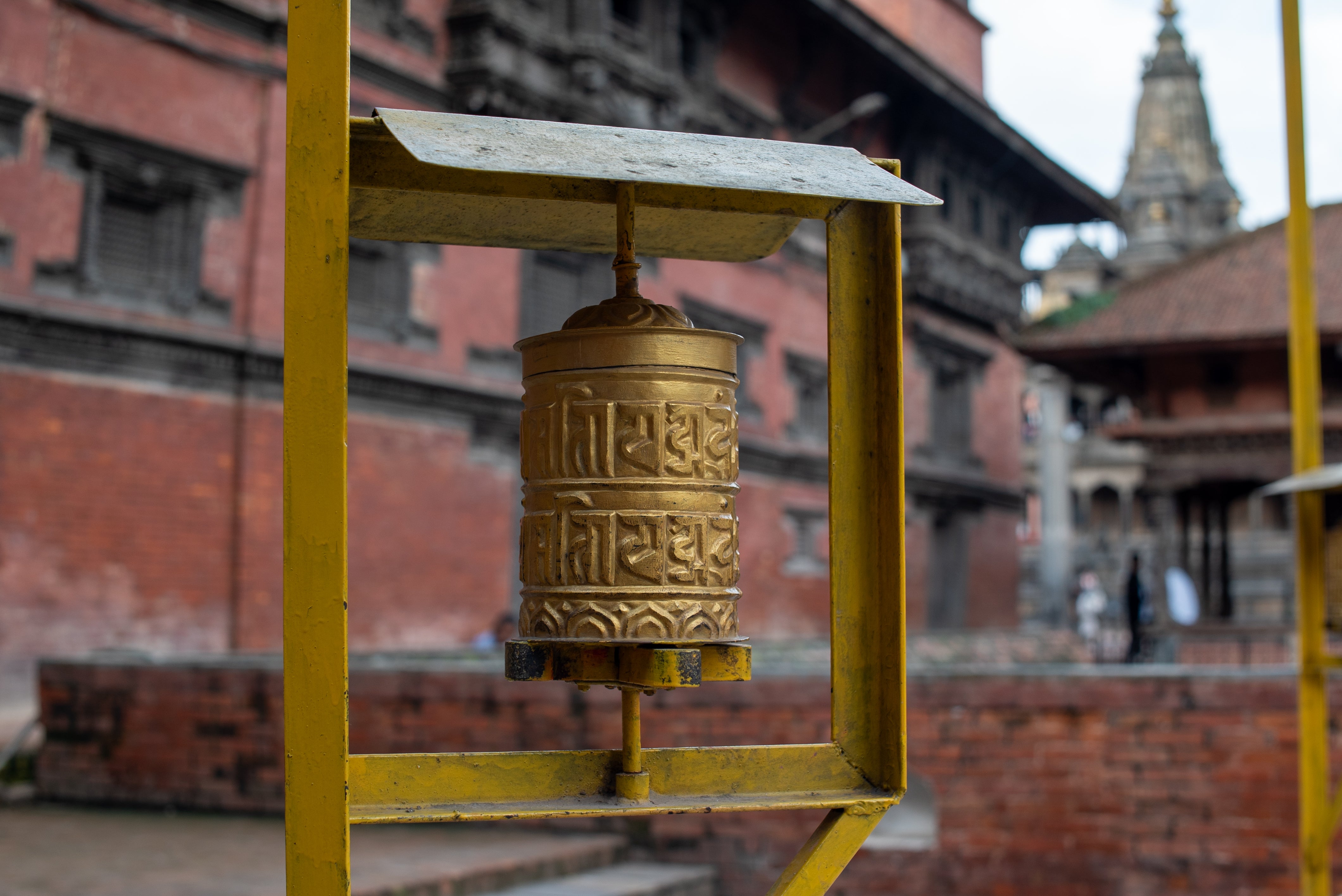 A prayer wheel at a red-brick shrine in Patan, Kathmandu Valley, Nepal