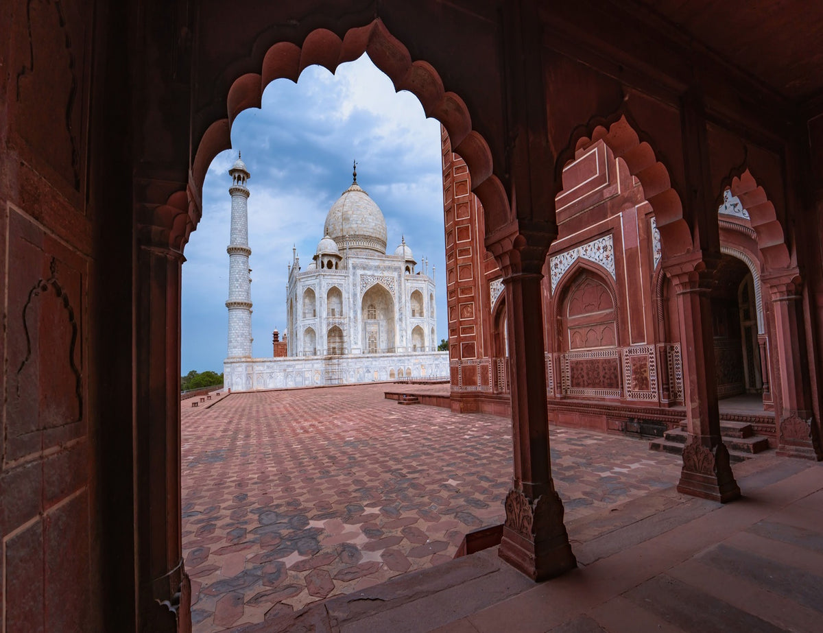 Taj Mahal through an arch in Agra, India.